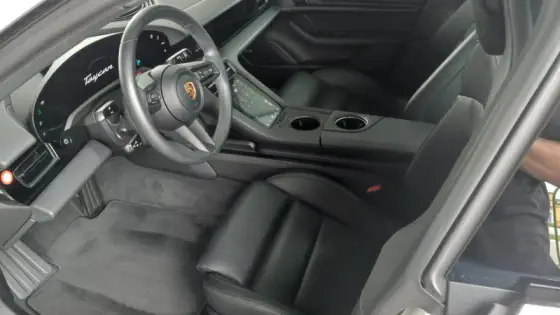 Porsche Taycan interior — clean leather seats and dashboard