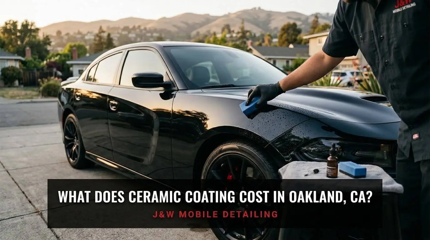 Black sedan freshly ceramic coated by J&W Mobile Detailing in an Oakland driveway