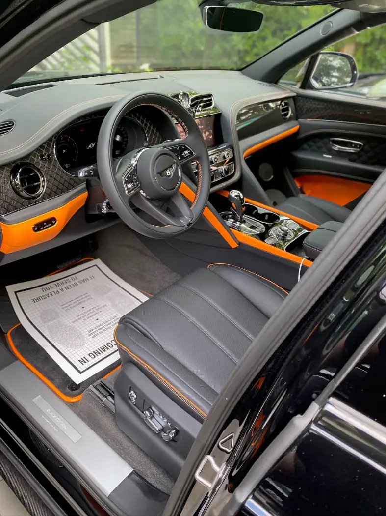 The orange and grey interior of a Bentley Bentayga after an Elite Restoration detail