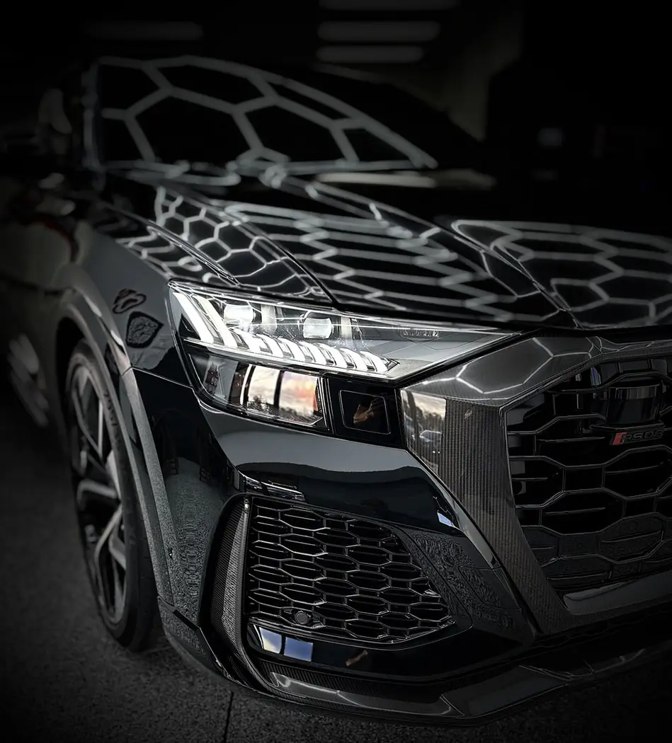 Black Audi RS Q8 with a fresh ceramic coating under hex lights at Greenville Detailing in Greenville, SC