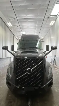 Black Volvo sleeper truck finished in a wash bay