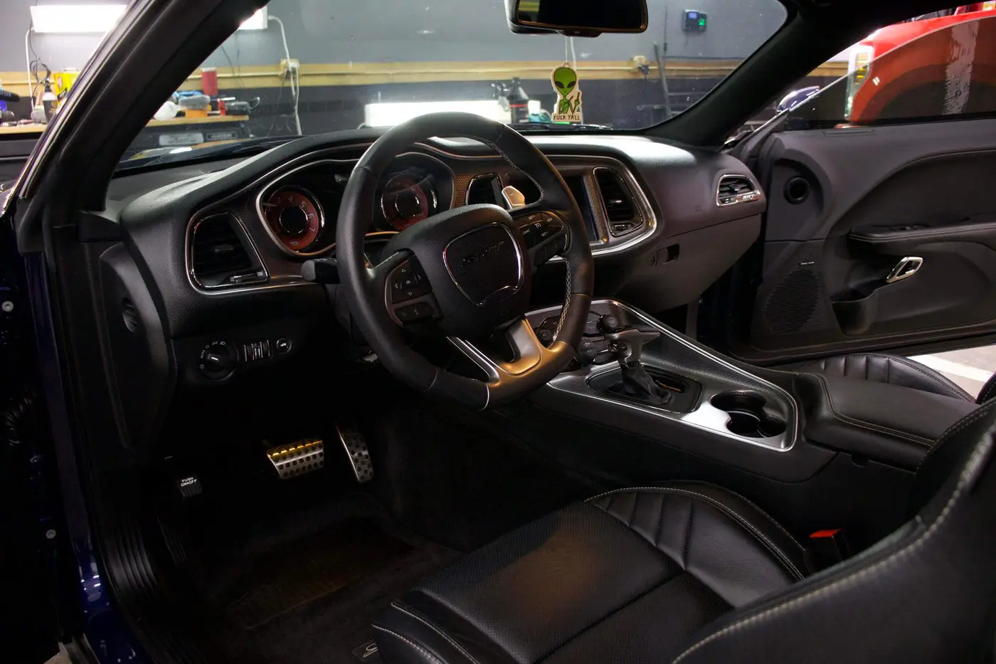A darkened vehicle cabin photographed from the driver seat
